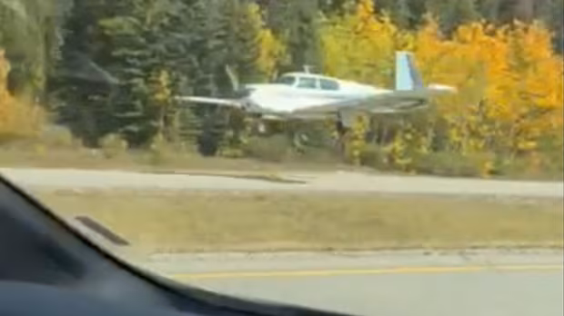 Plane lands on Highway 1 in Banff National Park